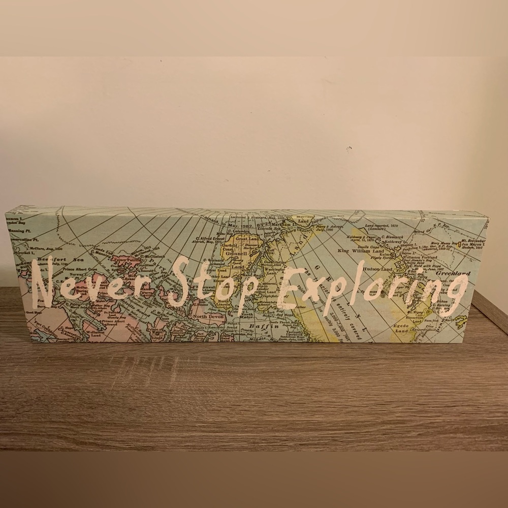 “Never Stop Exploring” wall hanging